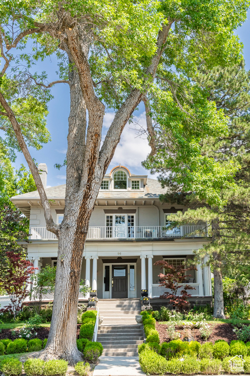 View of front of house with a balcony and a porch