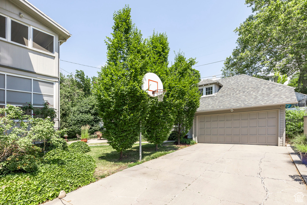 View of front of property featuring a garage and a front lawn