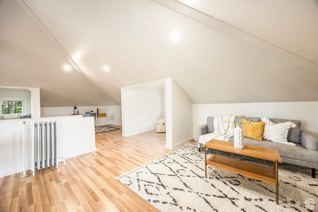 Interior space with light hardwood / wood-style floors and lofted ceiling