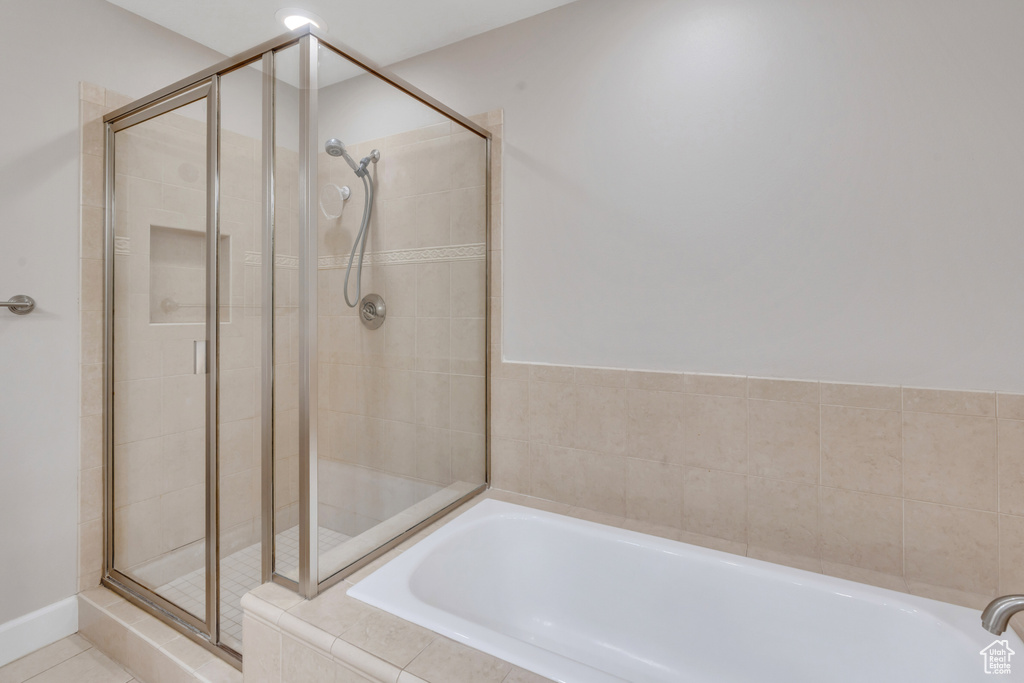 Bathroom featuring tile patterned floors and separate shower and tub