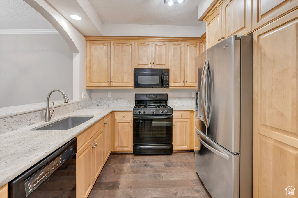 Kitchen with sink, dark hardwood / wood-style flooring, black appliances, and light brown cabinets