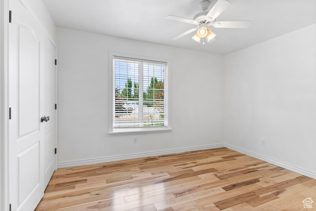 Unfurnished room featuring ceiling fan and light wood-type flooring