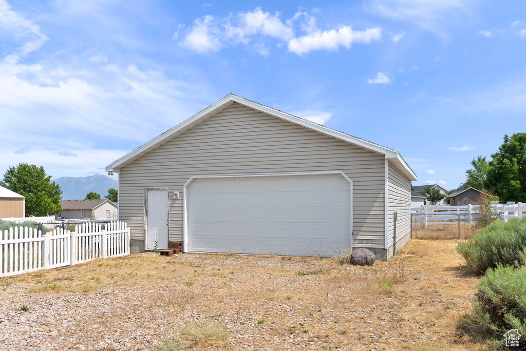 View of home\\\'s exterior featuring an outbuilding and a garage