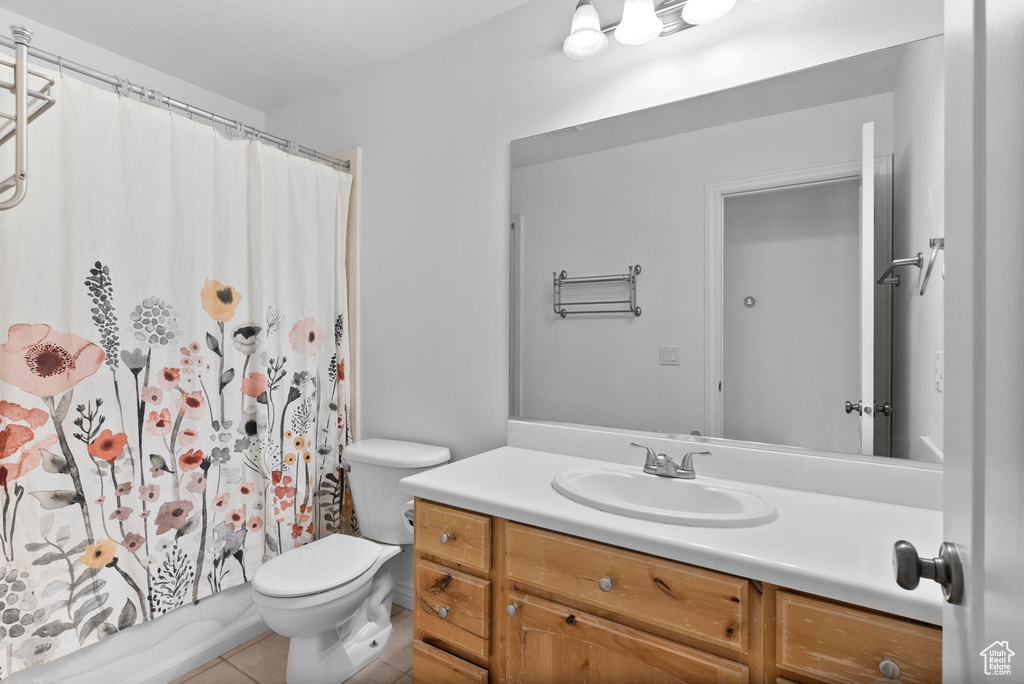 Bathroom featuring tile patterned floors, vanity, and toilet