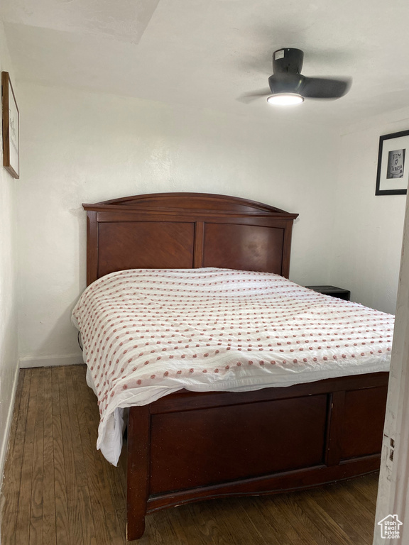Bedroom with dark hardwood / wood-style flooring and ceiling fan