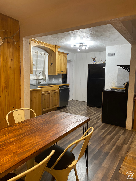 Dining room with sink, dark hardwood / wood-style flooring, and track lighting