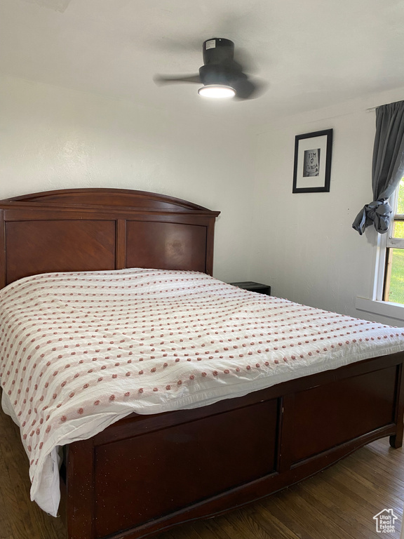 Bedroom featuring dark wood-type flooring and ceiling fan