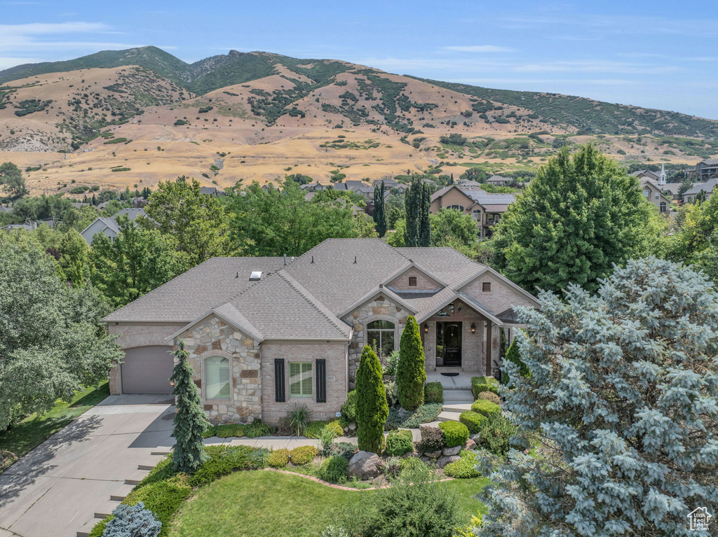 View of front facade with a mountain view and a garage