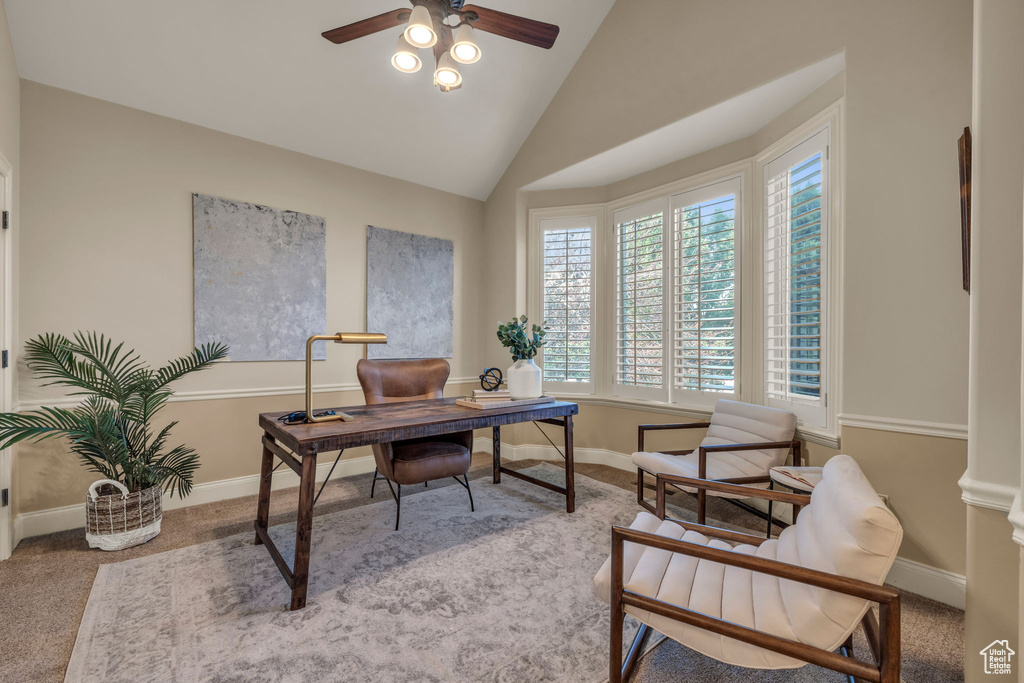 Home office featuring carpet flooring, vaulted ceiling, and ceiling fan