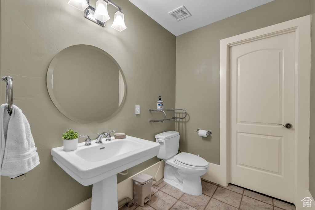 Bathroom featuring toilet and tile patterned floors