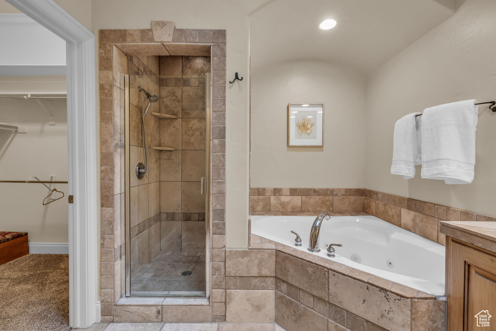 Bathroom featuring independent shower and bath and vanity