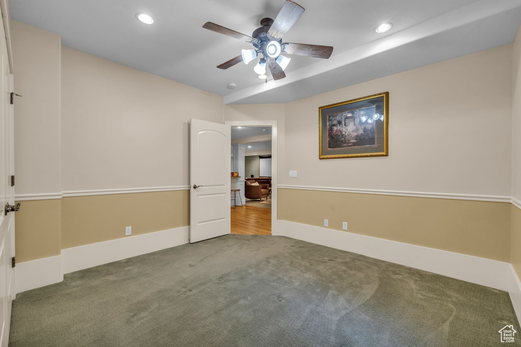 Empty room with dark wood-type flooring and ceiling fan