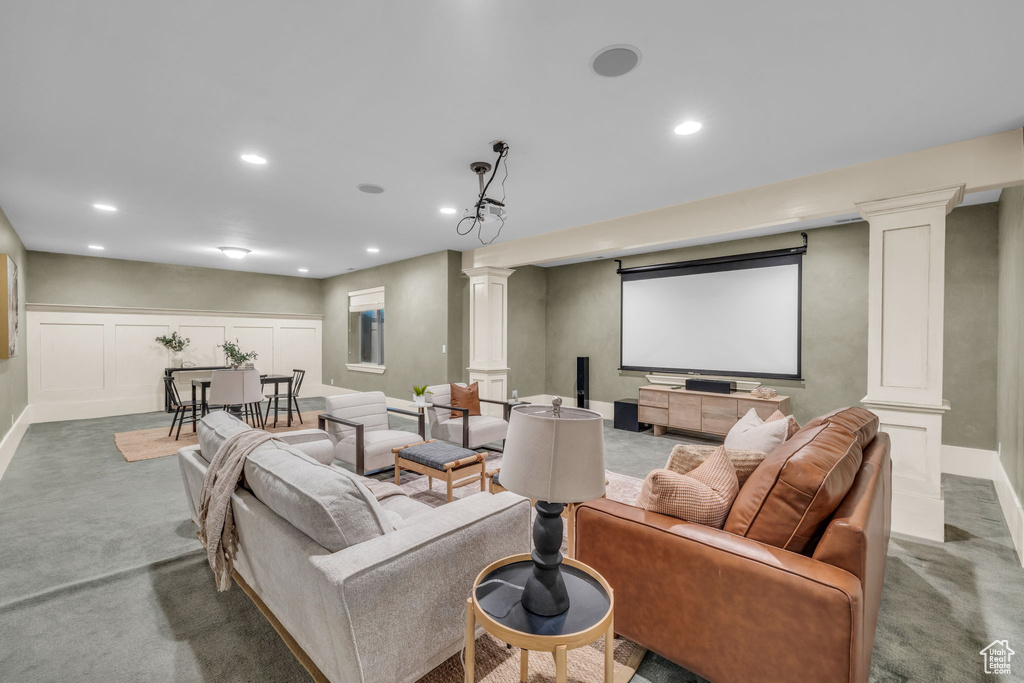 Carpeted home theater with ornate columns