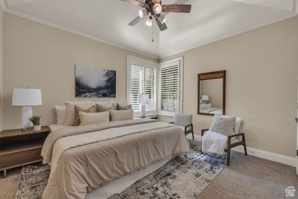 Bedroom with ornamental molding, ceiling fan, and carpet flooring