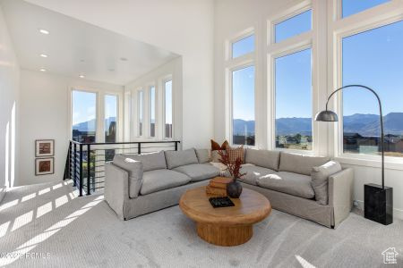 Carpeted living room featuring a mountain view