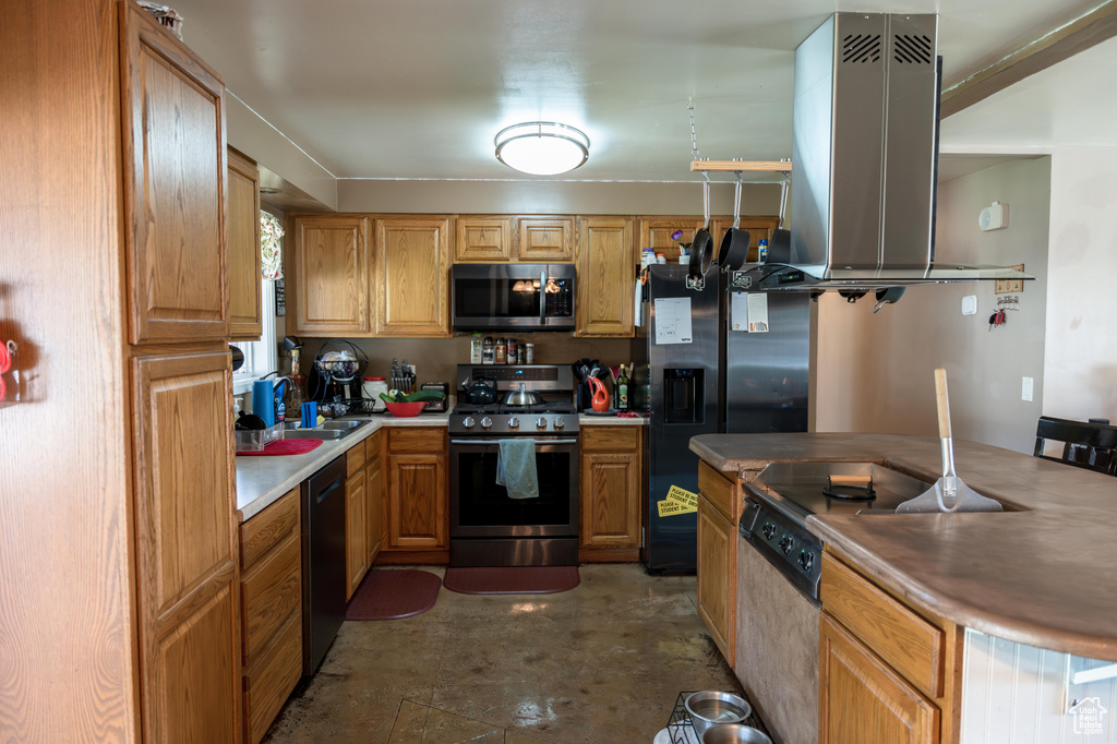 Kitchen with sink, appliances with stainless steel finishes, concrete floors, and extractor fan