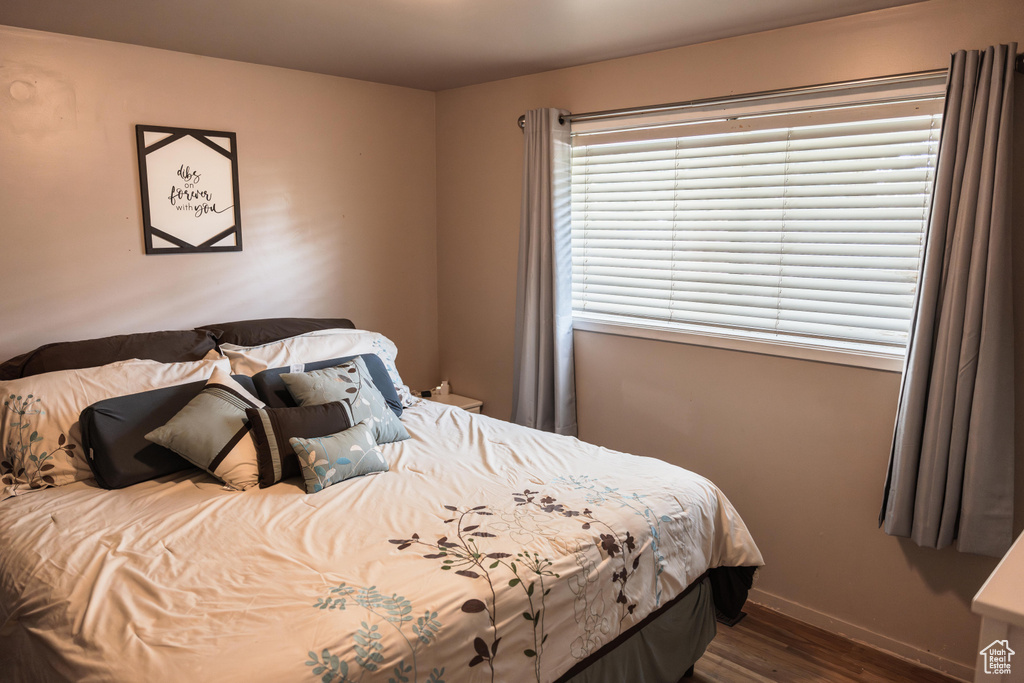 Bedroom with dark hardwood / wood-style floors