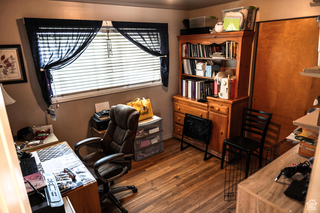 Office with dark wood-type flooring