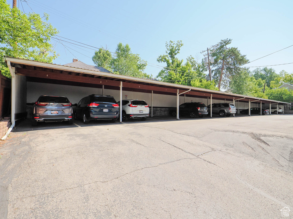 View of vehicle parking featuring a carport