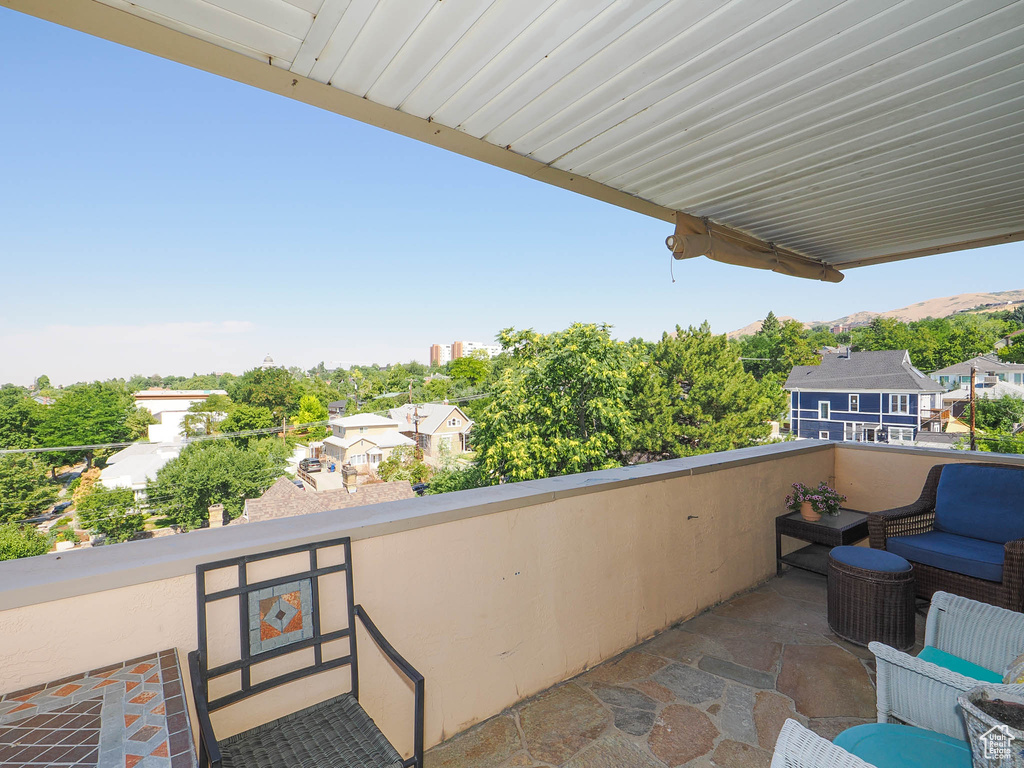 View of patio featuring a balcony