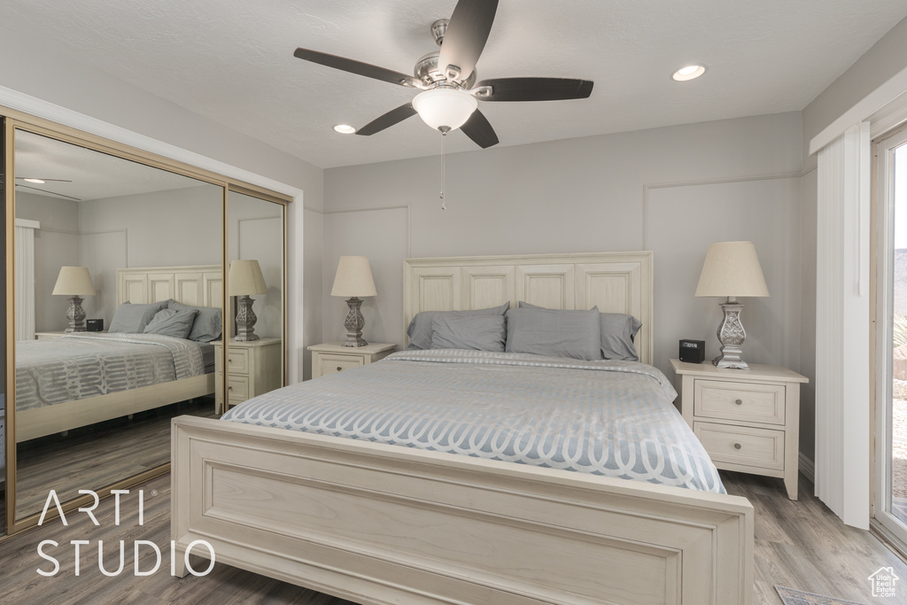 Bedroom featuring wood-type flooring, a closet, and ceiling fan