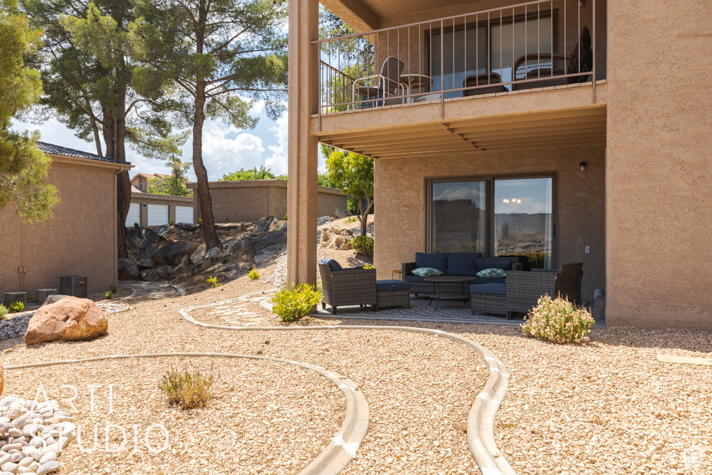 Exterior space featuring a balcony and an outdoor hangout area