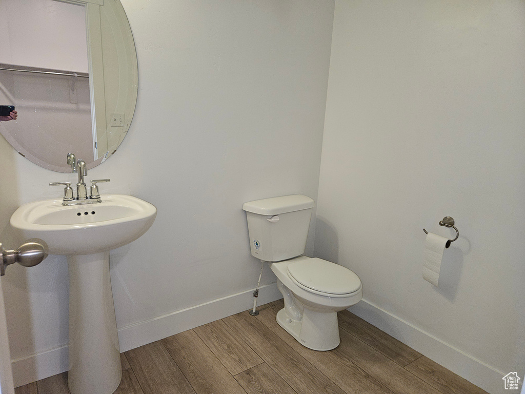 Bathroom with toilet and hardwood / wood-style floors