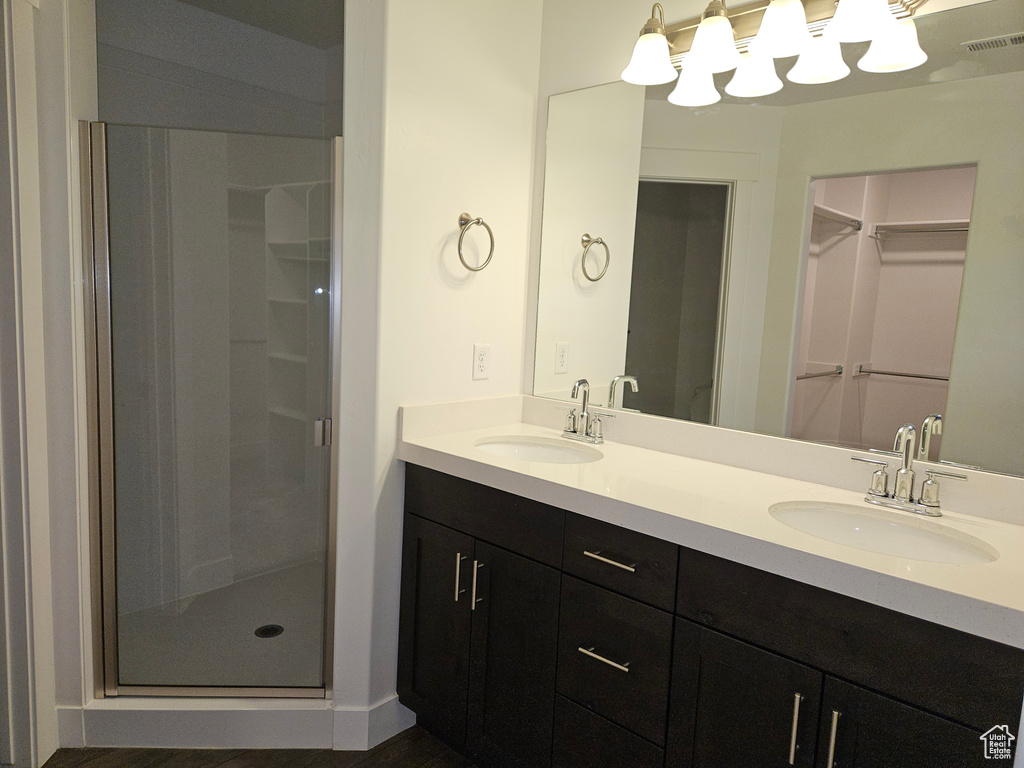 Bathroom with a shower with door and double vanity