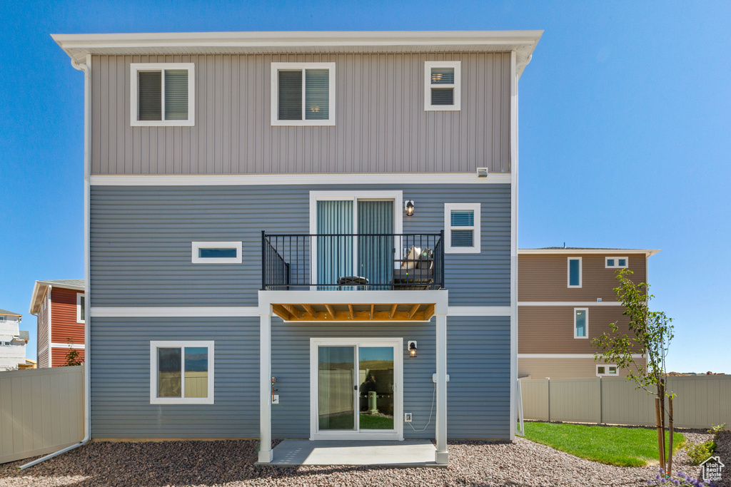 Rear view of property with a balcony