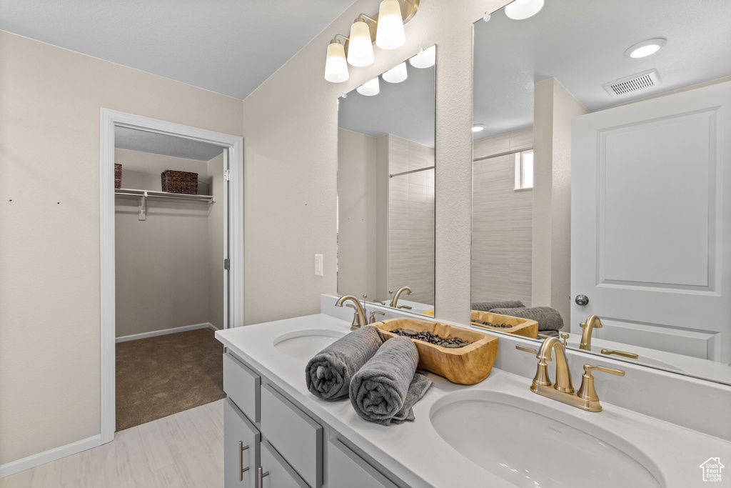 Bathroom featuring tile patterned flooring and dual bowl vanity