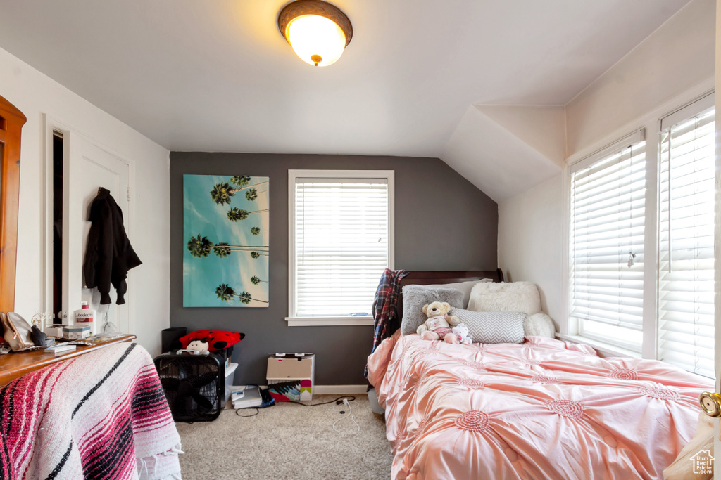 Bedroom with carpet and lofted ceiling