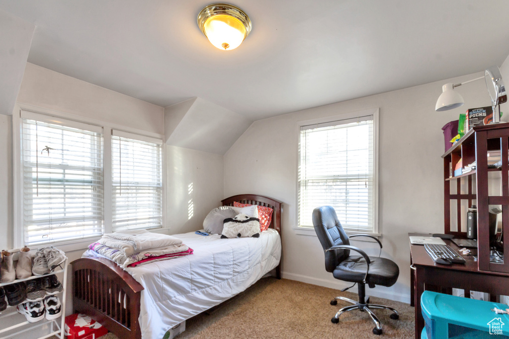 Carpeted bedroom featuring vaulted ceiling