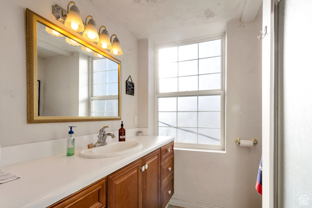 Bathroom featuring plenty of natural light and vanity