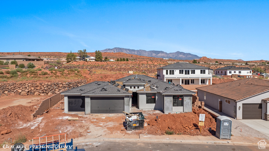 View of front of home with a garage and a mountain view