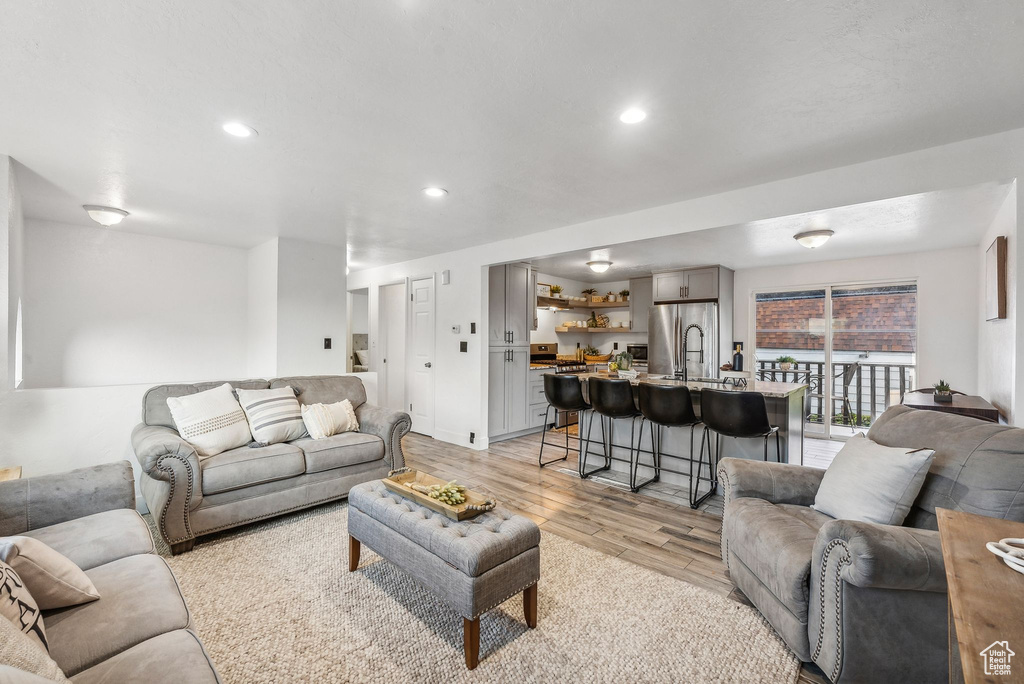 Living room featuring sink and light wood-type flooring