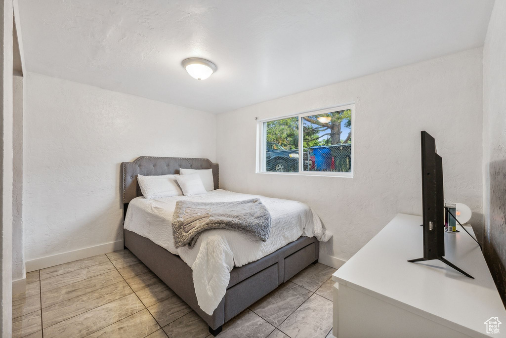 Bedroom with light tile patterned floors