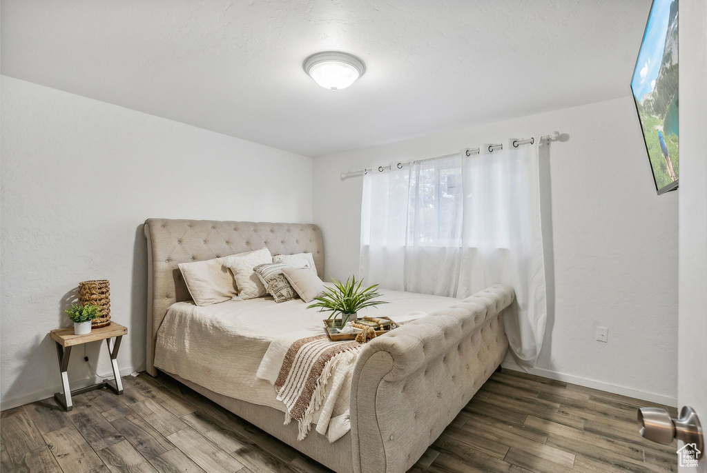 Bedroom featuring dark wood-type flooring