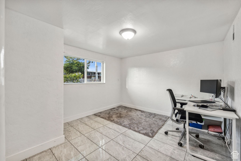 Office space with light tile patterned floors