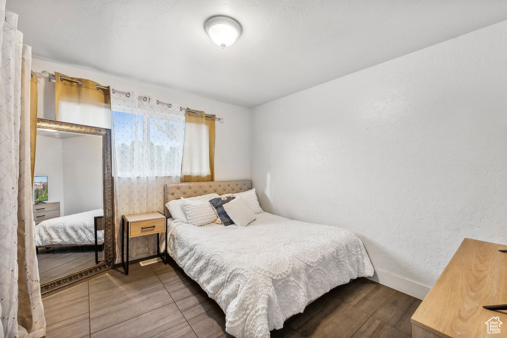 Bedroom with dark wood-type flooring