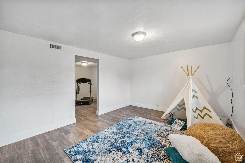 Bedroom with hardwood / wood-style floors