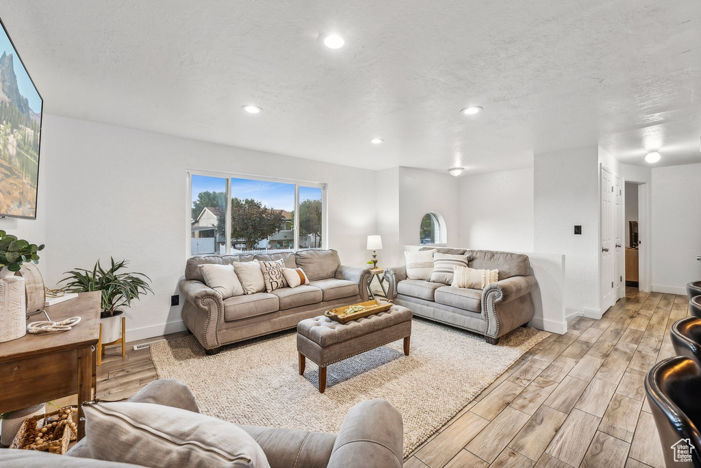 Living room with light hardwood / wood-style flooring