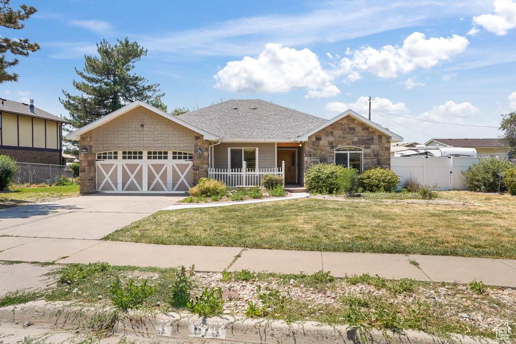 View of front of home featuring a garage and a front lawn