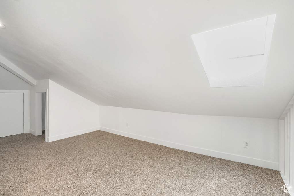 Bonus room with carpet floors and lofted ceiling