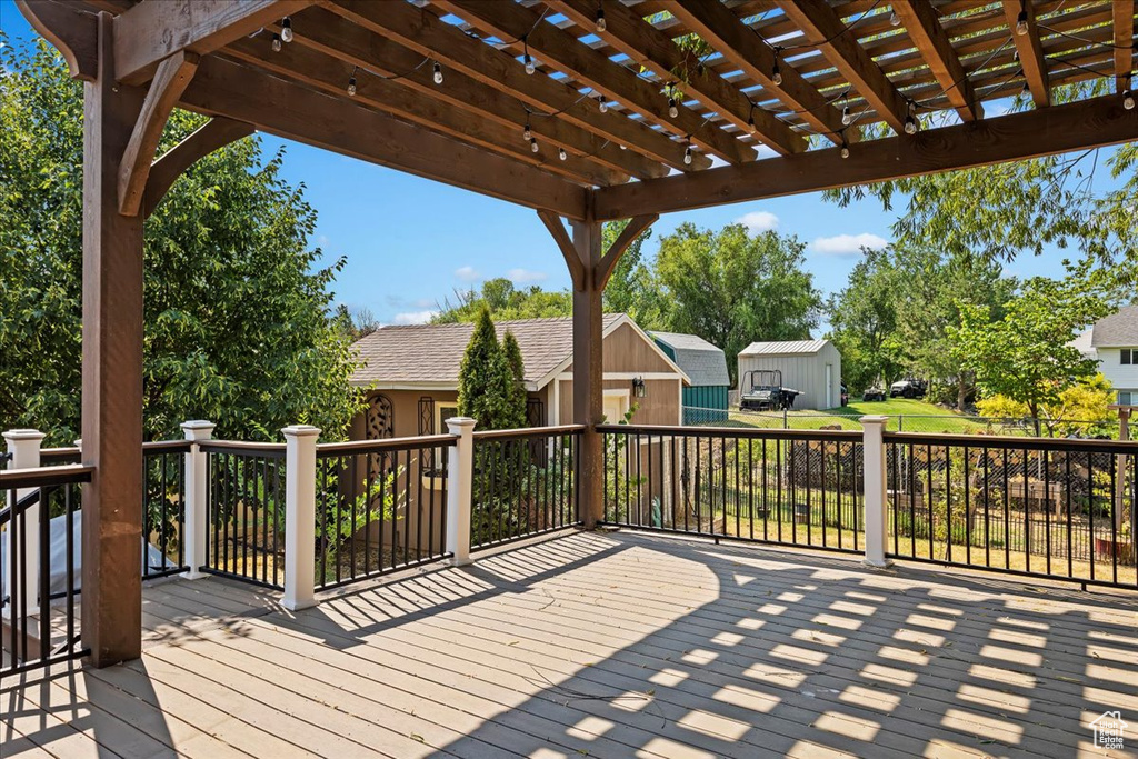 Wooden terrace with a pergola and an outdoor structure