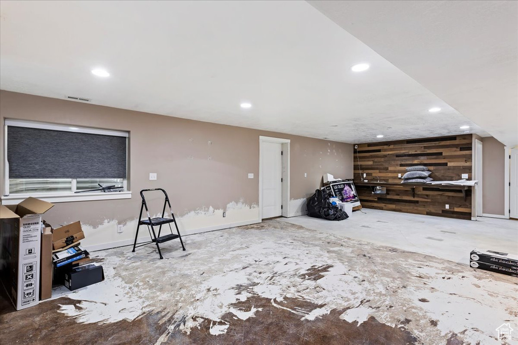 Living room featuring wood walls