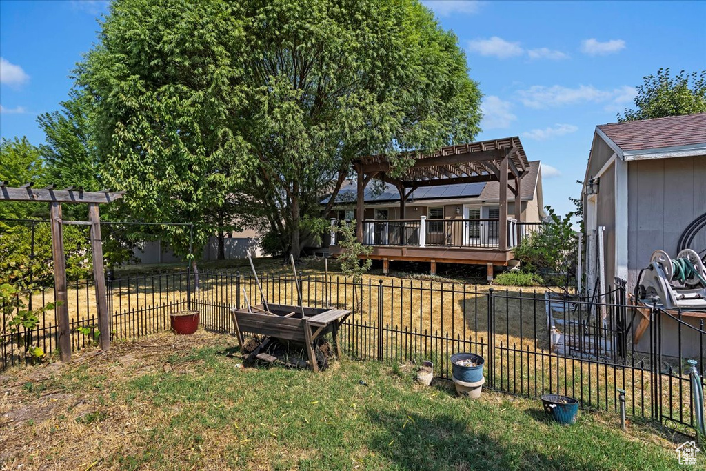 View of yard with a pergola and a wooden deck