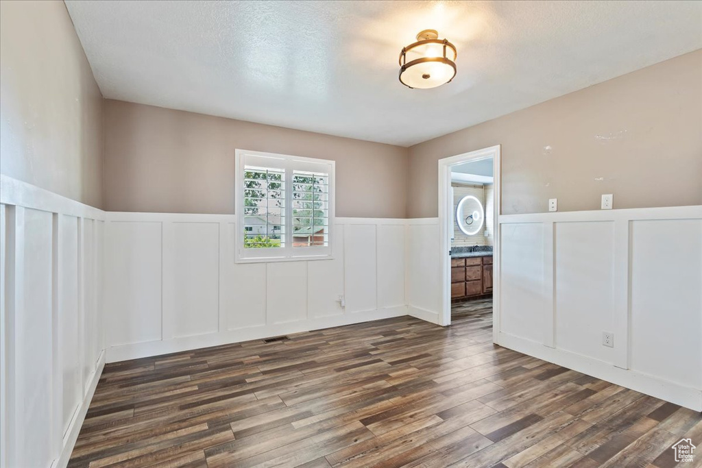 Empty room with dark hardwood / wood-style flooring