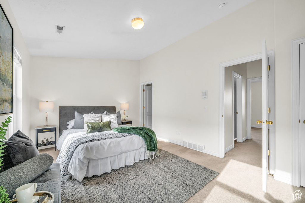 Bedroom with light colored carpet