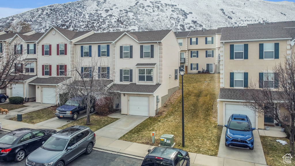 View of property featuring a mountain view and a garage