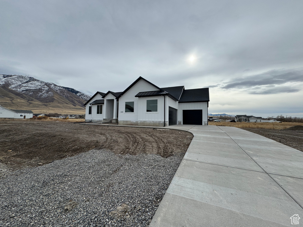 View of front of property featuring a mountain view and a garage